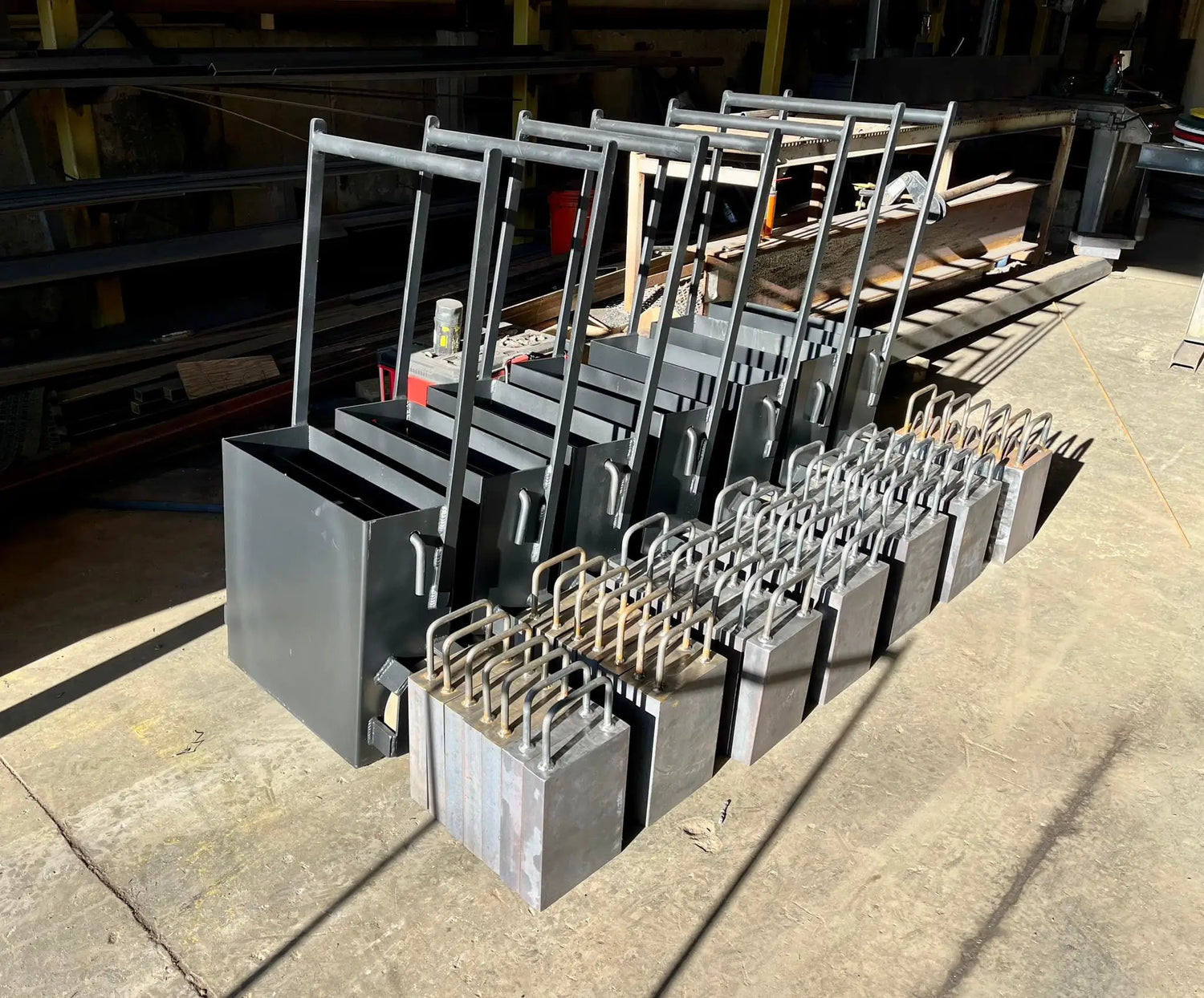 Row of metal forms on a concrete floor in an industrial setting